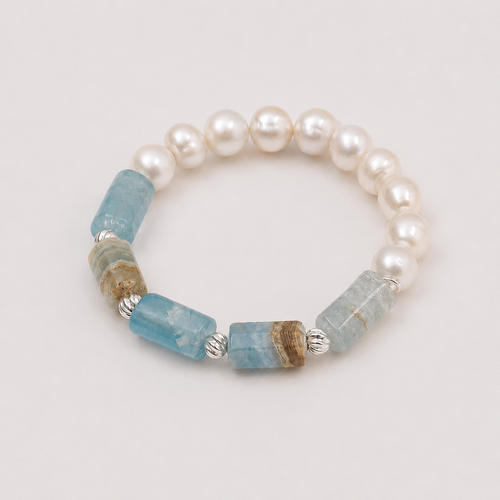 Cove blue apatite and freshwater pearl bracelet by MULAVEI on sandstone. jpg