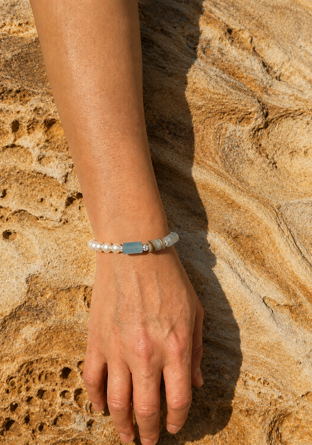 MULAVEI Cove freshwater pearl and blue apatite bracelet worn on wrist. jpg