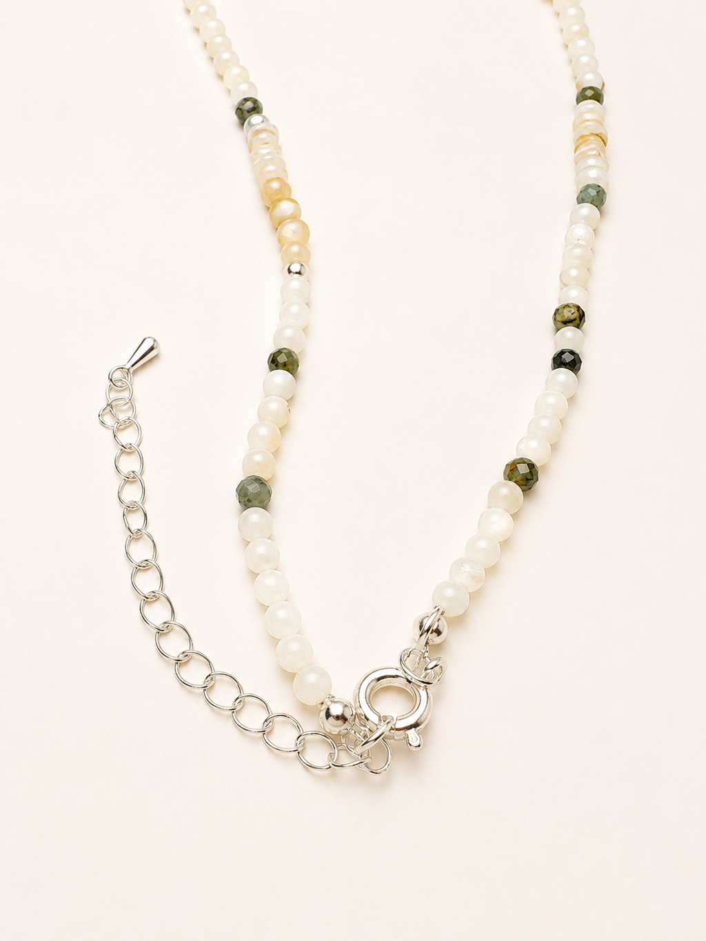 Adjustable clasp and extender chain detail on handmade pearl cat charm necklace.