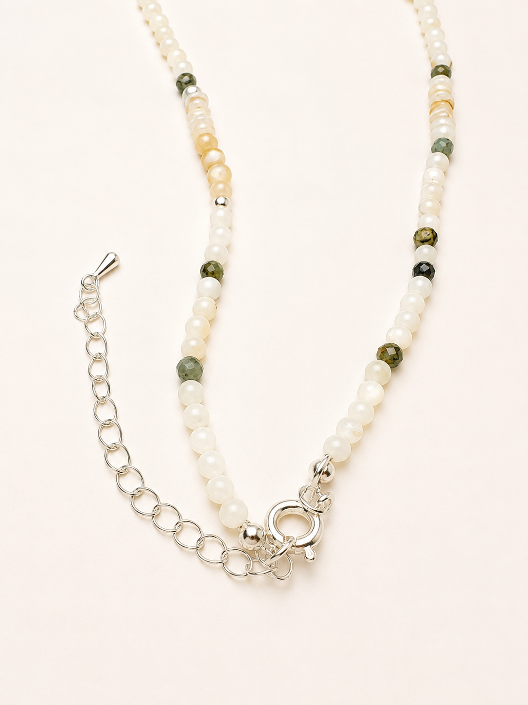 Adjustable clasp and extender chain detail on handmade pearl cat charm necklace.